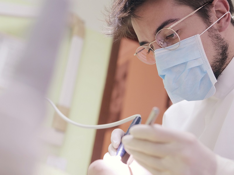 man-in-white-shirt-holding-dental-tools-3779695
